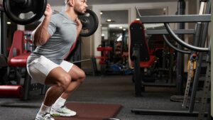 Fitness Man Doing Barbell Squats