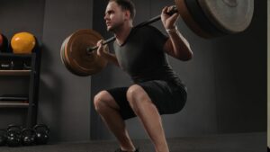 Man doing squats exercise with barbell