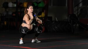 Pregnant female athlete doing goblet squats