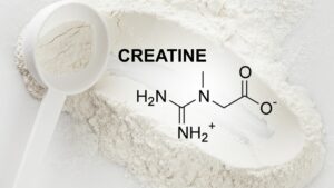 Scoop of Creatine Monohydrate Supplement and Chemical Formula