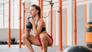 Sportswoman doing kettlebell goblet squat