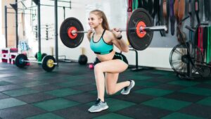 Woman Exercise with Barbells In The Gym