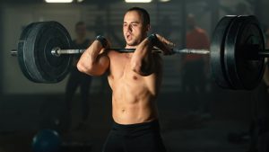 muscular-build-man-lifting-barbell-strength-training-gym.j