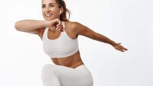 portrait-sportswoman-stretching-body-exercising-doing-fitness-leg-raise-smiling-running-standing-white-background.jpg