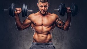 powerful-stylish-bodybuilder-with-tattoo-his-arm-doing-exercises-with-dumbbells-isolated-dark-background.jpg