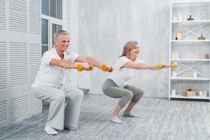smiling-elder-couple-performing-exercise-with-dumbbells-home.jpg