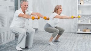 smiling-elder-couple-performing-exercise-with-dumbbells-home.jpg