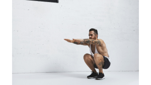 strong-tattooed-white-unlabeled-tank-t-shirt-male-athlete-shows-calisthenic-moves-squat-calf-rises-low-position.j