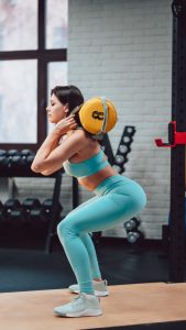 young-adult-woman-doing-strength-exercises-gym.