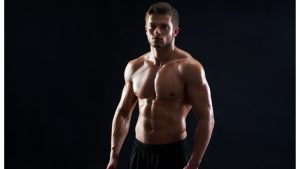 young-muscular-fit-sportsman-posing-shirtless-black-backgroun.jpg