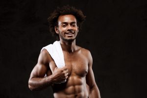 young-sportive-african-man-posing-black-wall