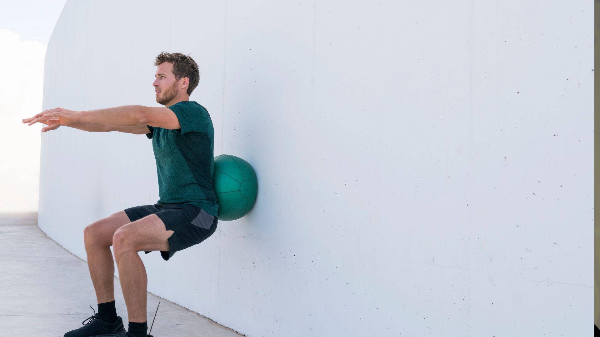 Strength Training Man Doing Medicine Ball Squats