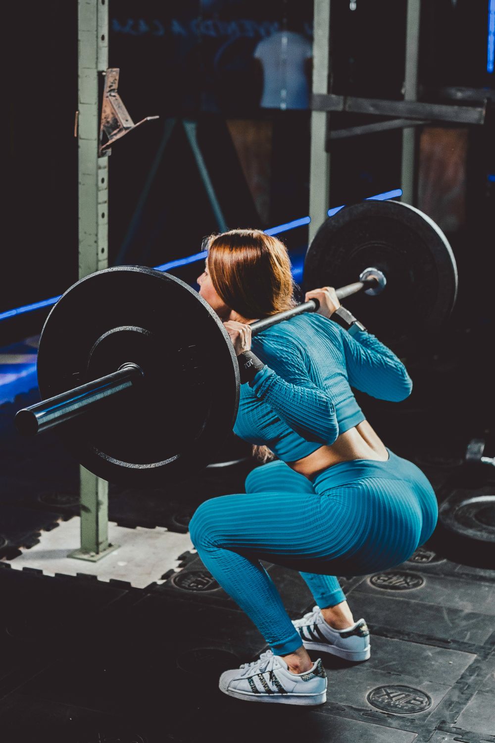 A Woman Doing Squats at the Gym
