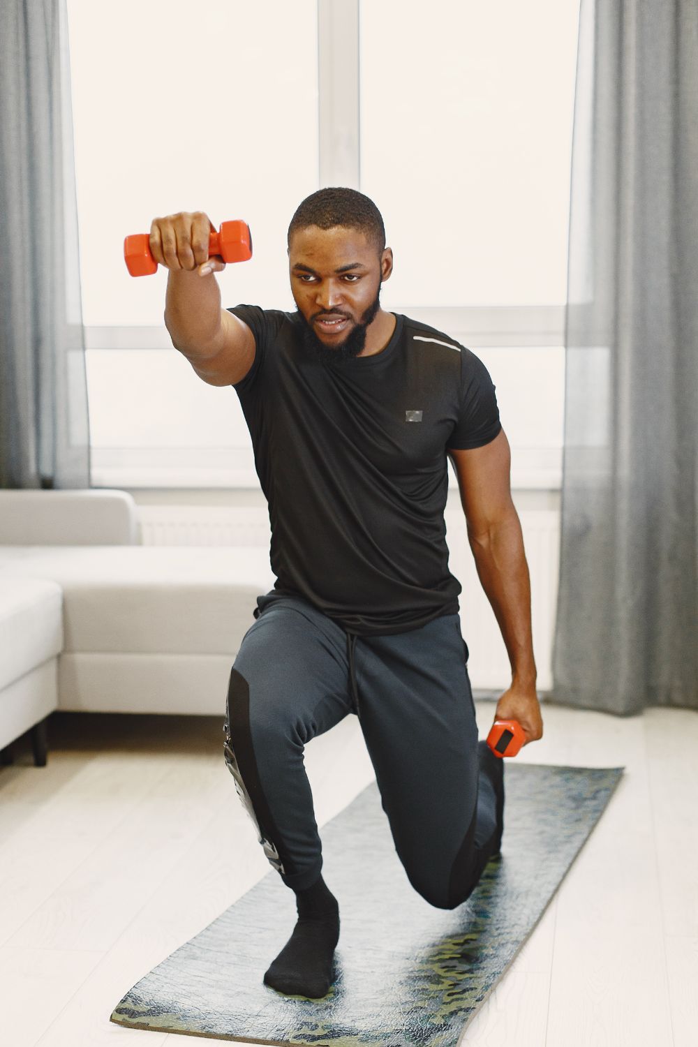 Home workout, closeup of athletic man doing lunges with kettlebell at home