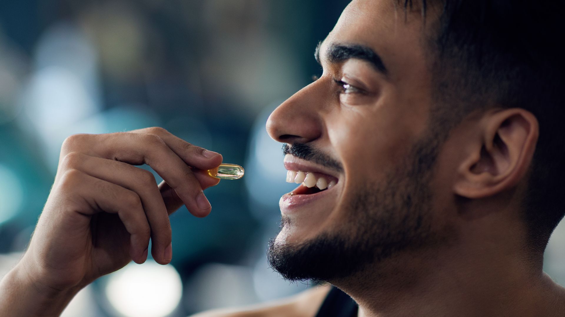 Portrait of Happy Sportive Arab Man Taking Supplement Pill Capsule