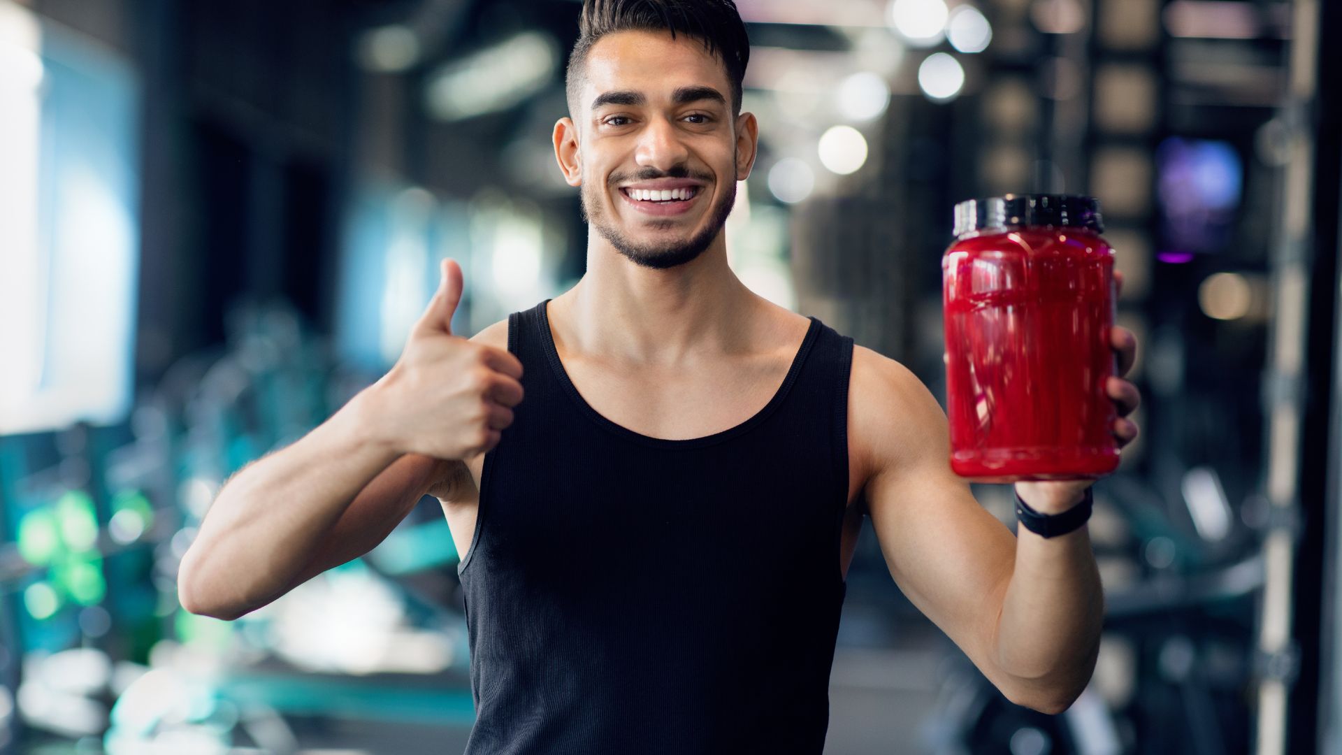 Workout Supplements. Handsome Middle Eastern Male Athlete Holding Container with Protein Powder