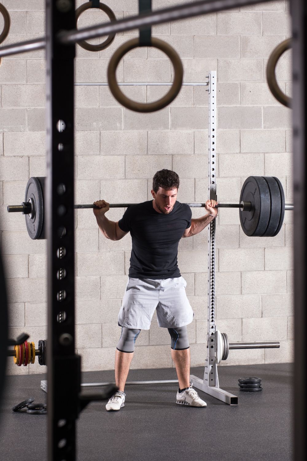 Bodybuilder Exercising on Squat Rack