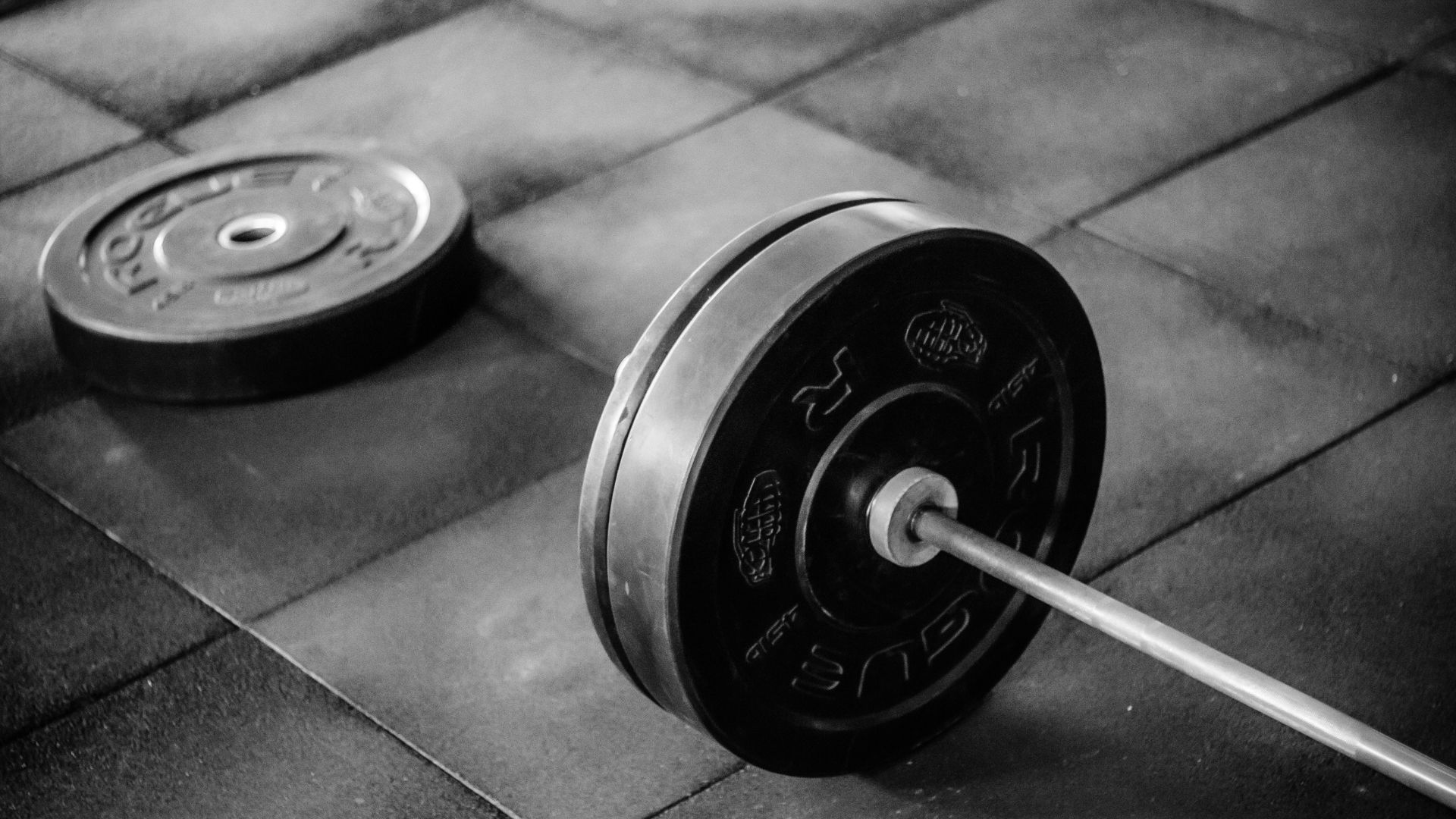 Grayscale Photo of Black Adjustable Barbell